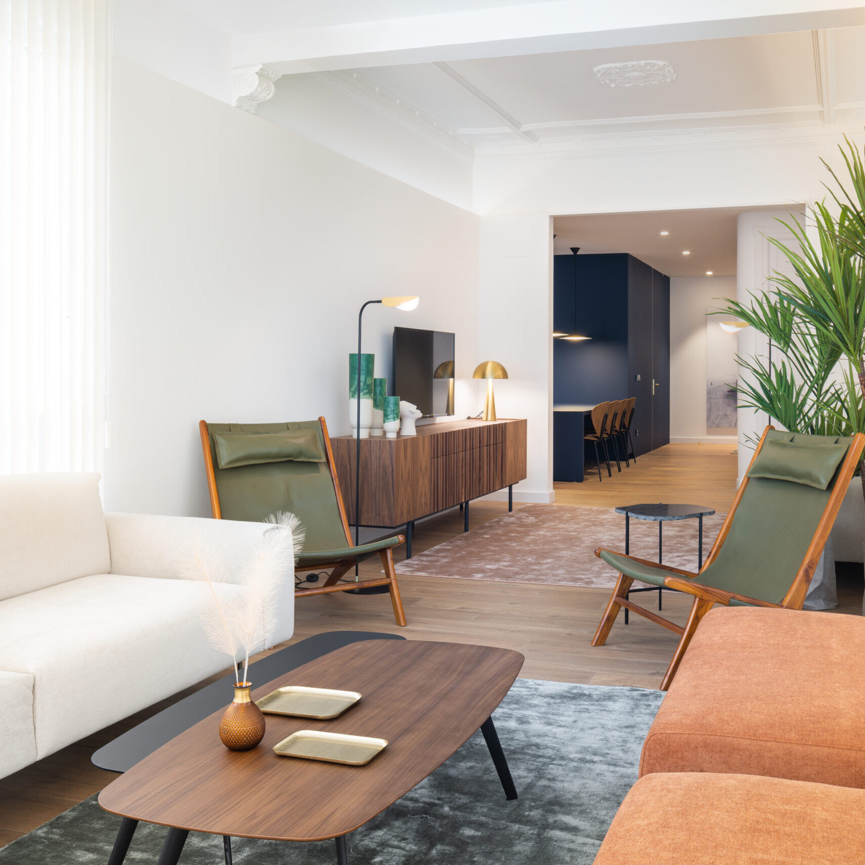 Spacious living room with sofa and chairs